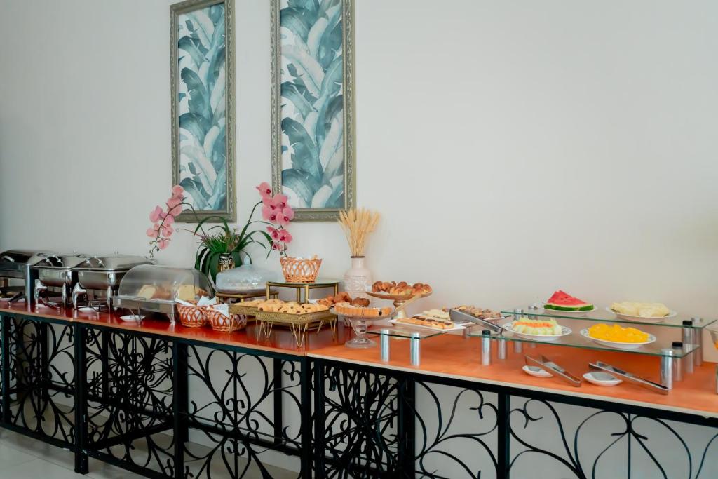a buffet with a lot of food on it at Megal Suites Hotel in Ciudad del Este