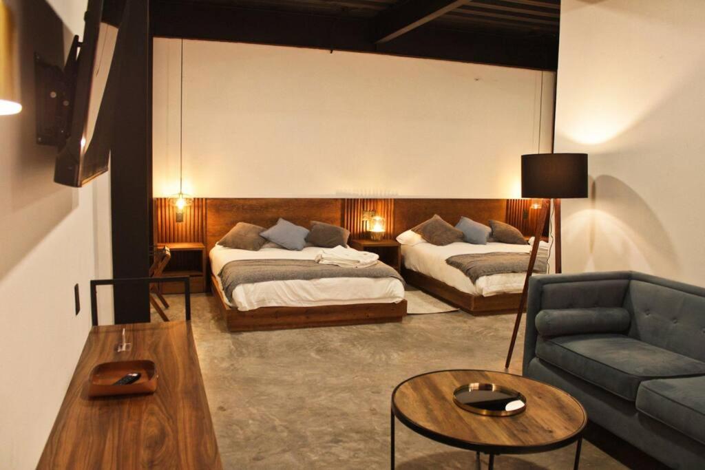 a living room with two beds and a couch at Loft níquel en excelente ubicación! in San Luis Potosí