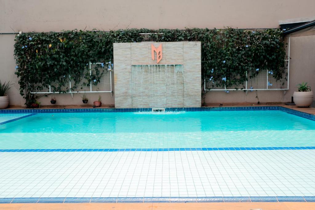 a large swimming pool in a building at Megal Suites Hotel in Ciudad del Este