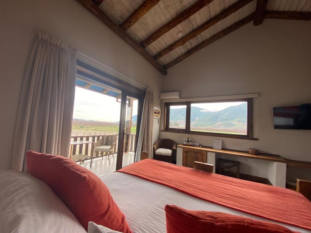 a bedroom with a bed and a large window at Hotel Casa De Campo in Santa Cruz