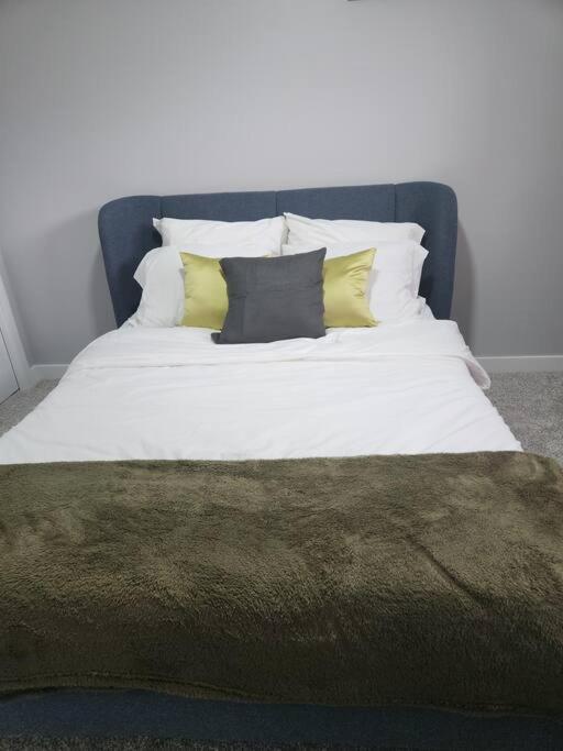 a bed with four pillows and a blanket on it at Basement suite in Winnipeg in Winnipeg