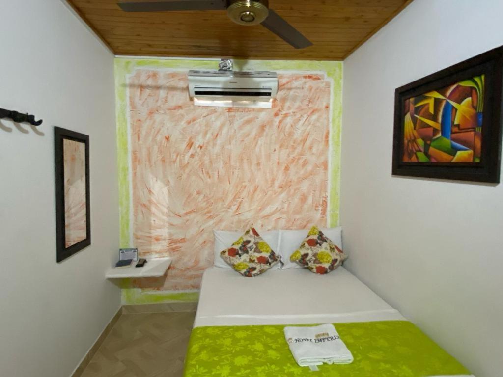 Postel nebo postele na pokoji v ubytování Hotel imperial