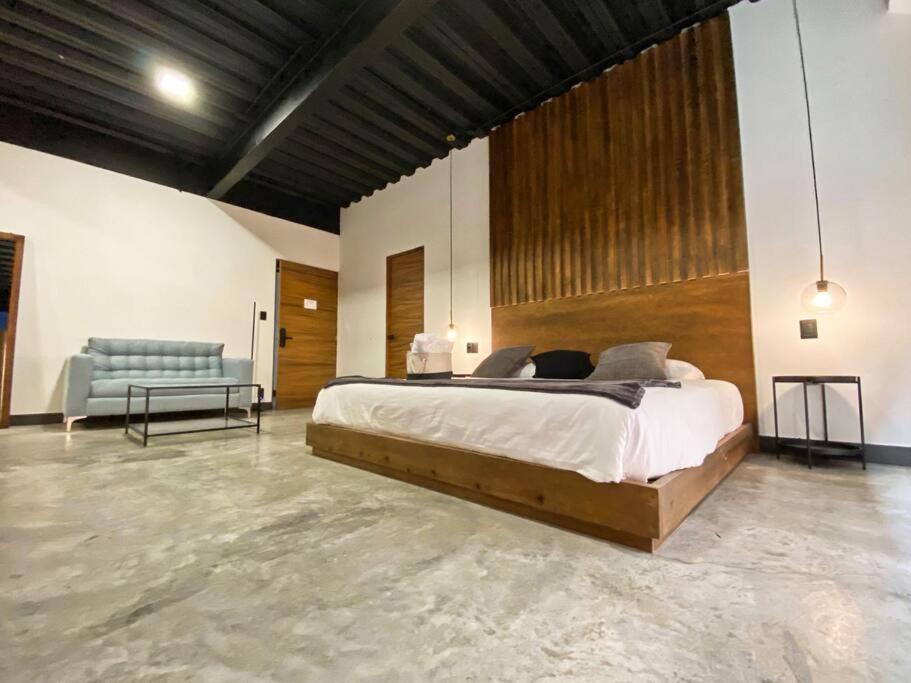 a large bedroom with a large bed and a couch at Loft cromo en excelente ubicación! in San Luis Potosí
