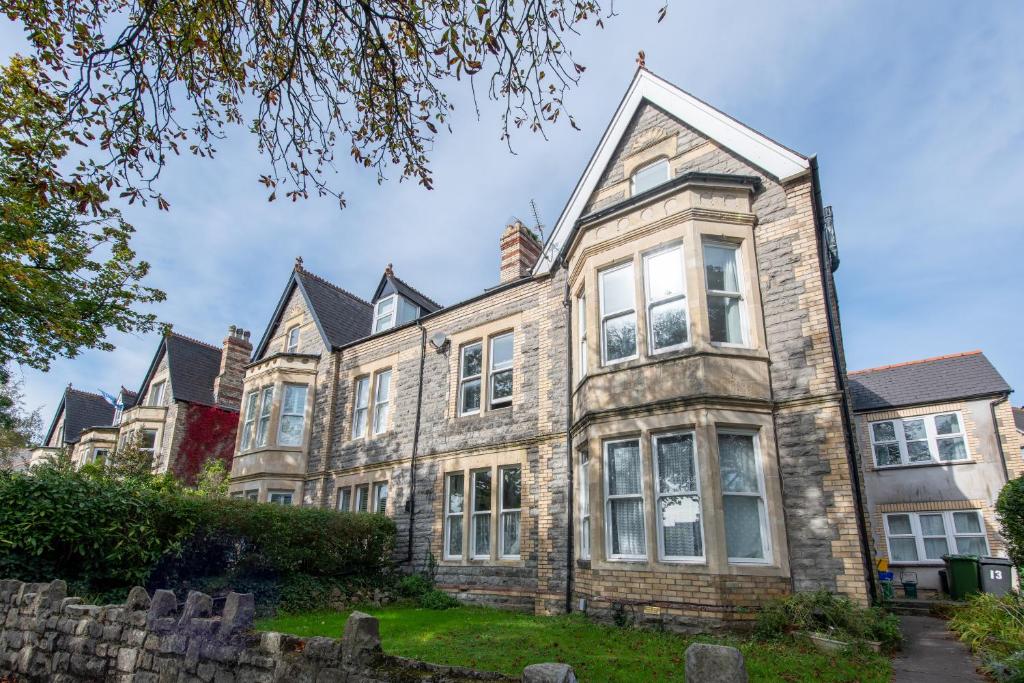 an old stone house with a turret at 13 Victoria Road Apartment in Cardiff