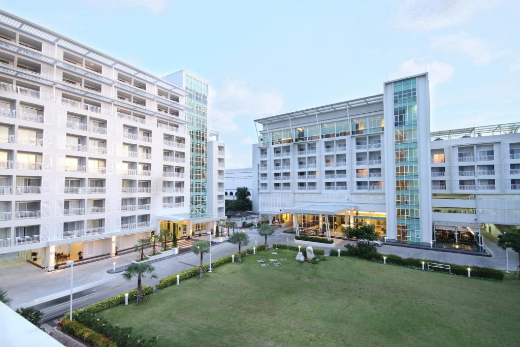 an aerial view of two tall buildings with a park at Kameo Grand Hotel & Serviced Apartment, Rayong in Rayong