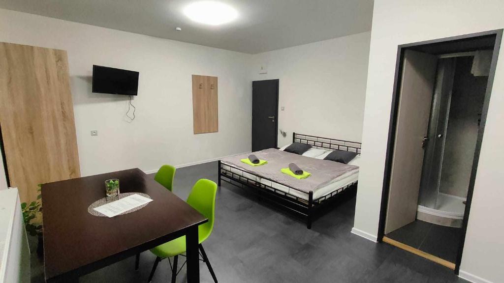 Apartmány u golfu في جيهلافا: غرفة بسرير وطاولة وكراسي