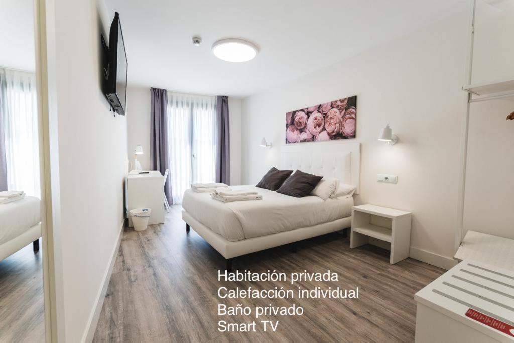 Postel nebo postele na pokoji v ubytování Hostal Comfort Suites