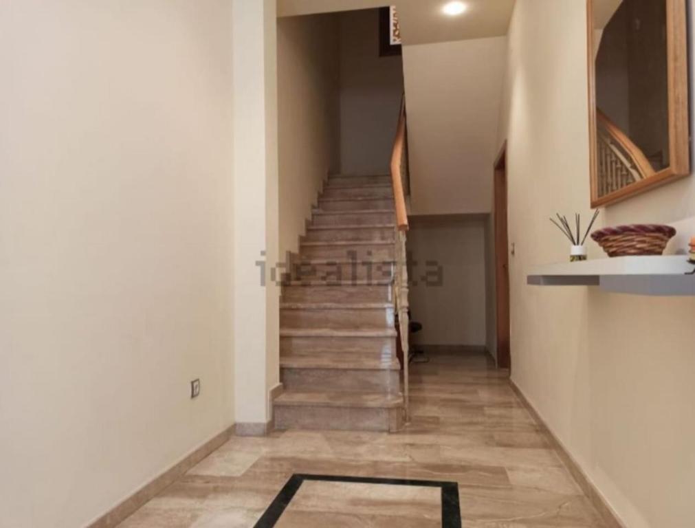 a hallway with stairs and a rug on the floor at Vivienda Planta Baja in Algemesí