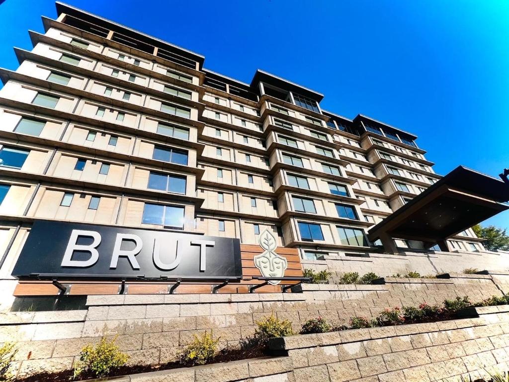 タルサにあるBrut Hotelの看板が目の前にある大きな建物