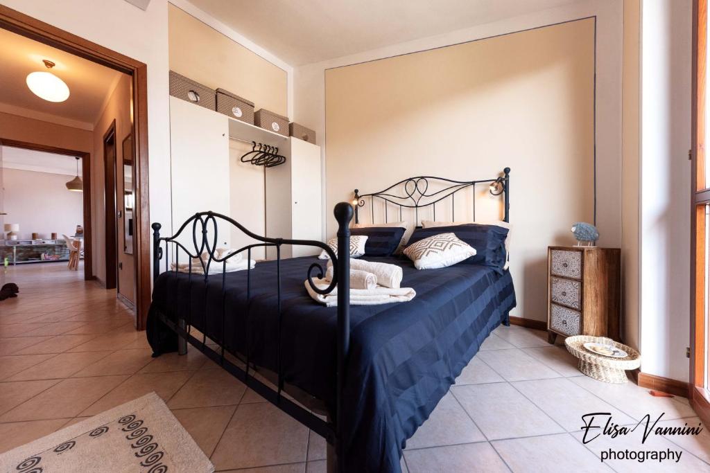 a bedroom with a bed with a blue comforter at Terrazza Sulla Luna in Casciana Terme