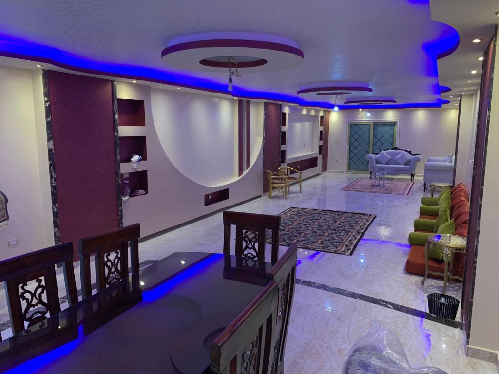 a living room with blue lights on the ceiling at Osama Fwaz in Cairo