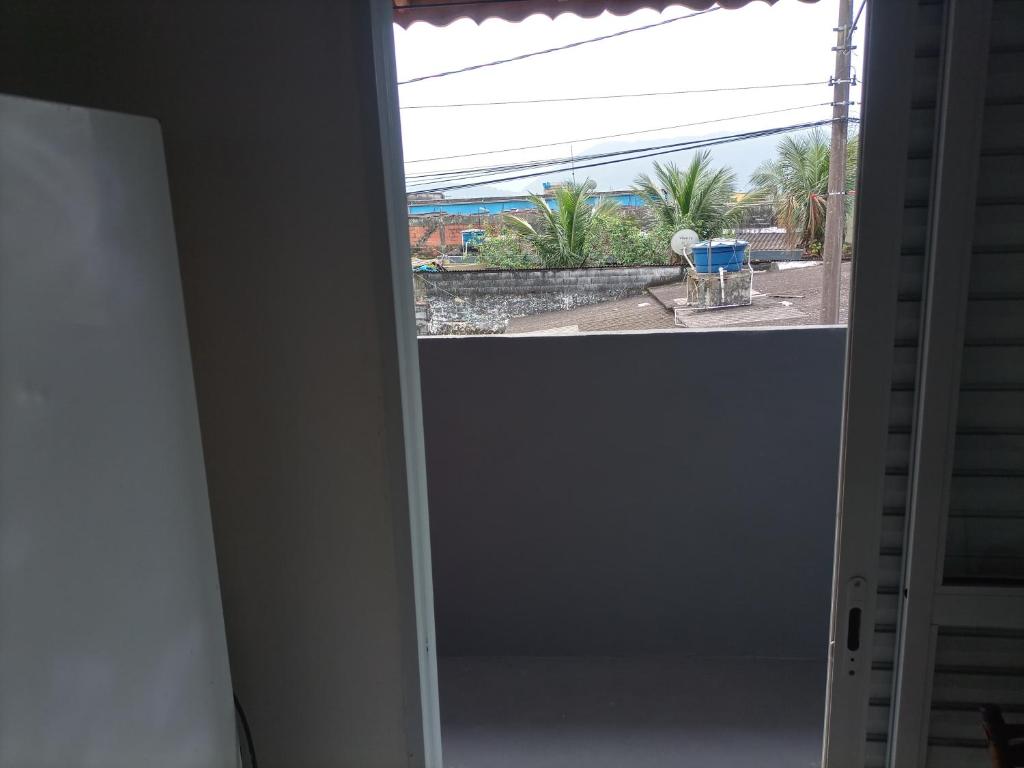 an open door with a view of a patio at Recanto da paz 2 in Solemar