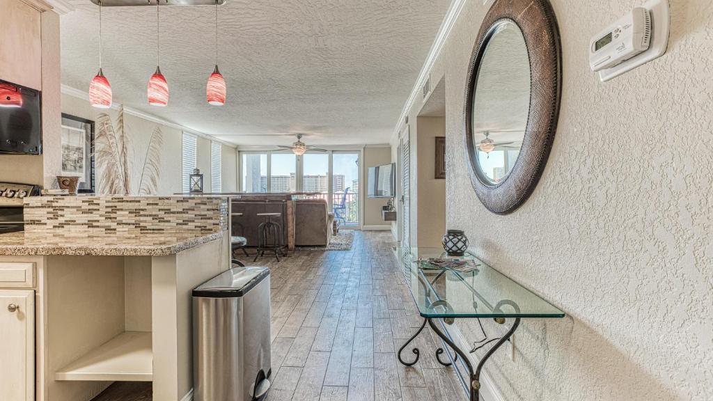 a kitchen with a counter and a mirror on the wall at Dolphin Point 402B - 2BR on Holiday Isle in Destin
