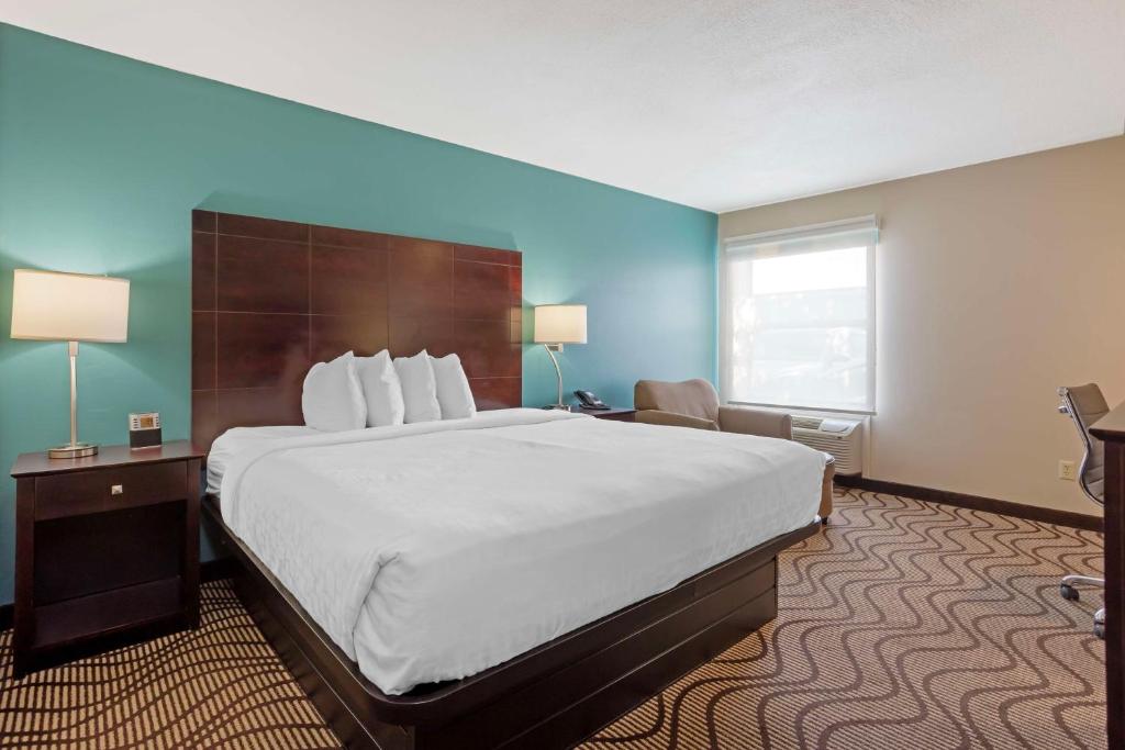 a hotel room with a large bed and a window at Best Western Plus Lonoke Hotel in Lonoke