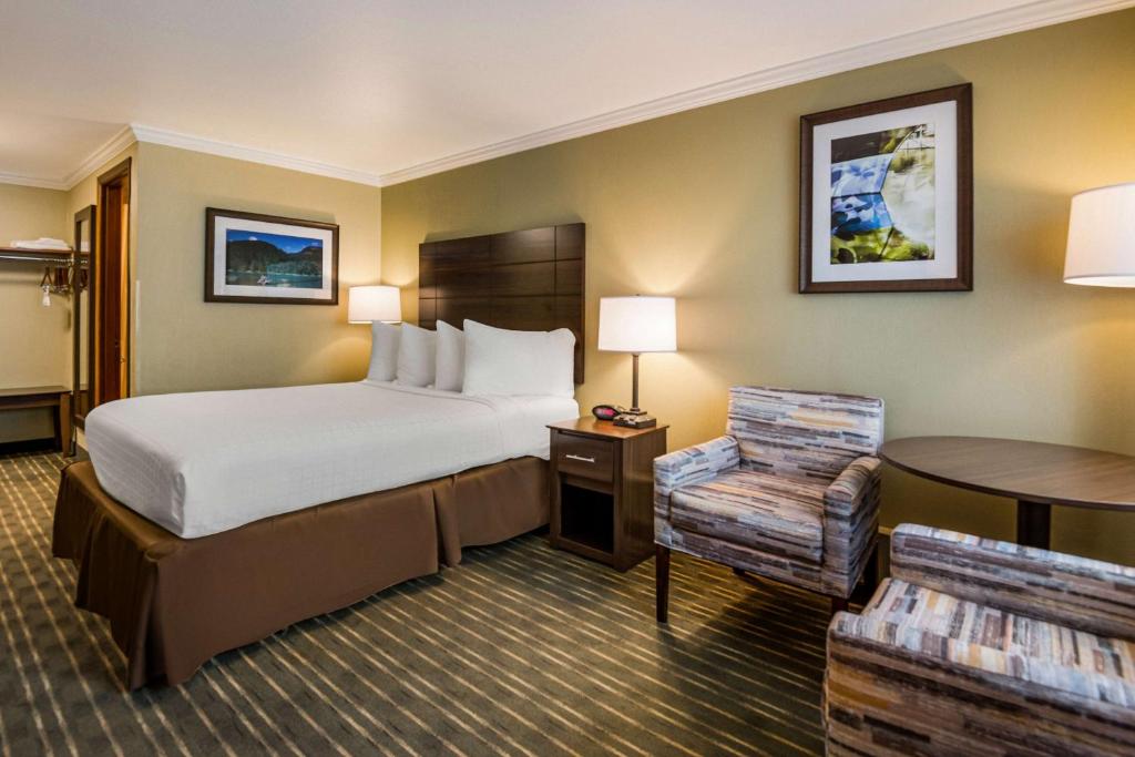 a hotel room with a bed and a table at Best Western Holiday Hotel in Coos Bay