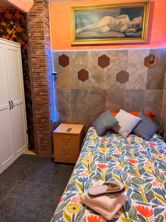 ein Schlafzimmer mit einem Bett und einem Wandgemälde in der Unterkunft Bonita Habitación en chalet in Barcelona