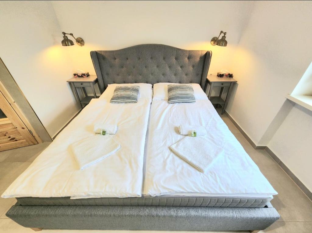a bedroom with a bed with two pillows on it at Ron De Mar #1 modern room in Pezinok