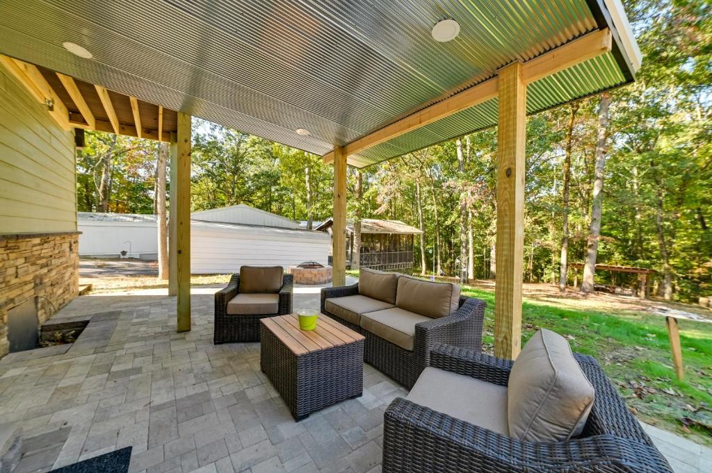 a patio with couches and chairs and a table at Pet-Friendly Springville Cabin Near Kentucky Lake! in Durham Subdivision