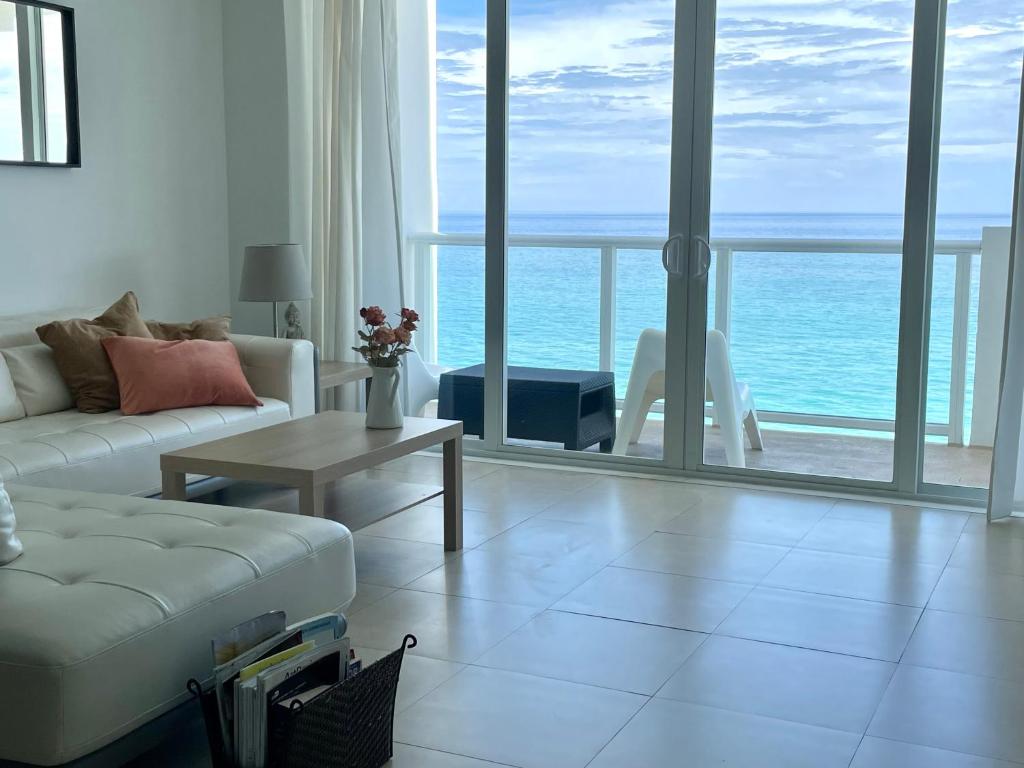 a living room with a couch and a view of the ocean at Pavilion - Great ocean view -Miami Beach in Miami Beach