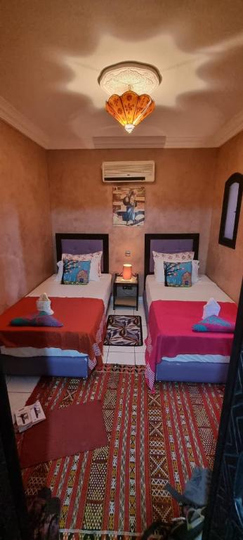 Postel nebo postele na pokoji v ubytování RIAD GREEN LOTUS