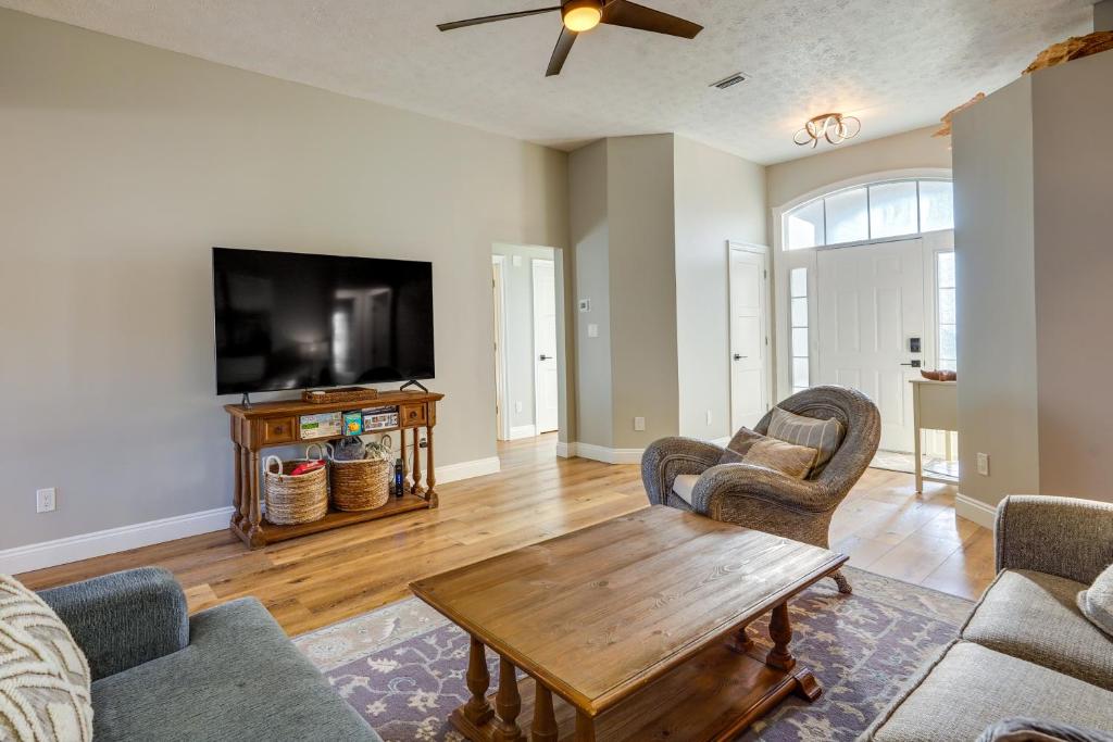 a living room with a table and a tv at Family-Friendly PCB Vacation Rental, Walk to Beach in Panama City Beach