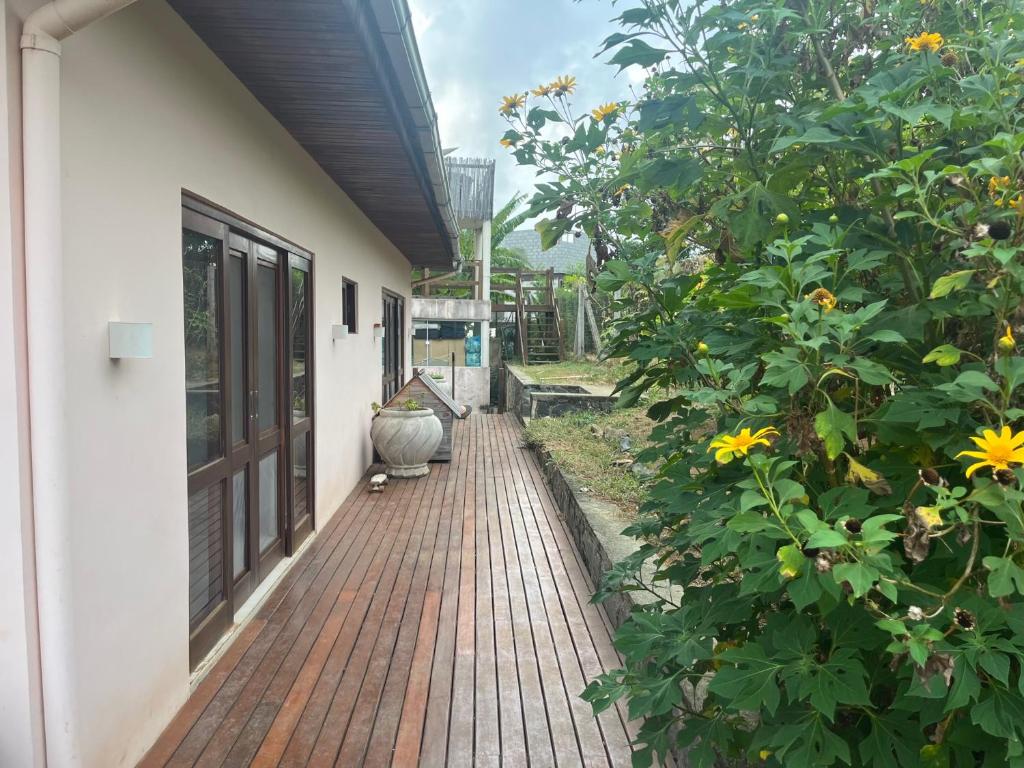 a porch with a brick walkway next to a house at Suites Amma Noronha in Fernando de Noronha
