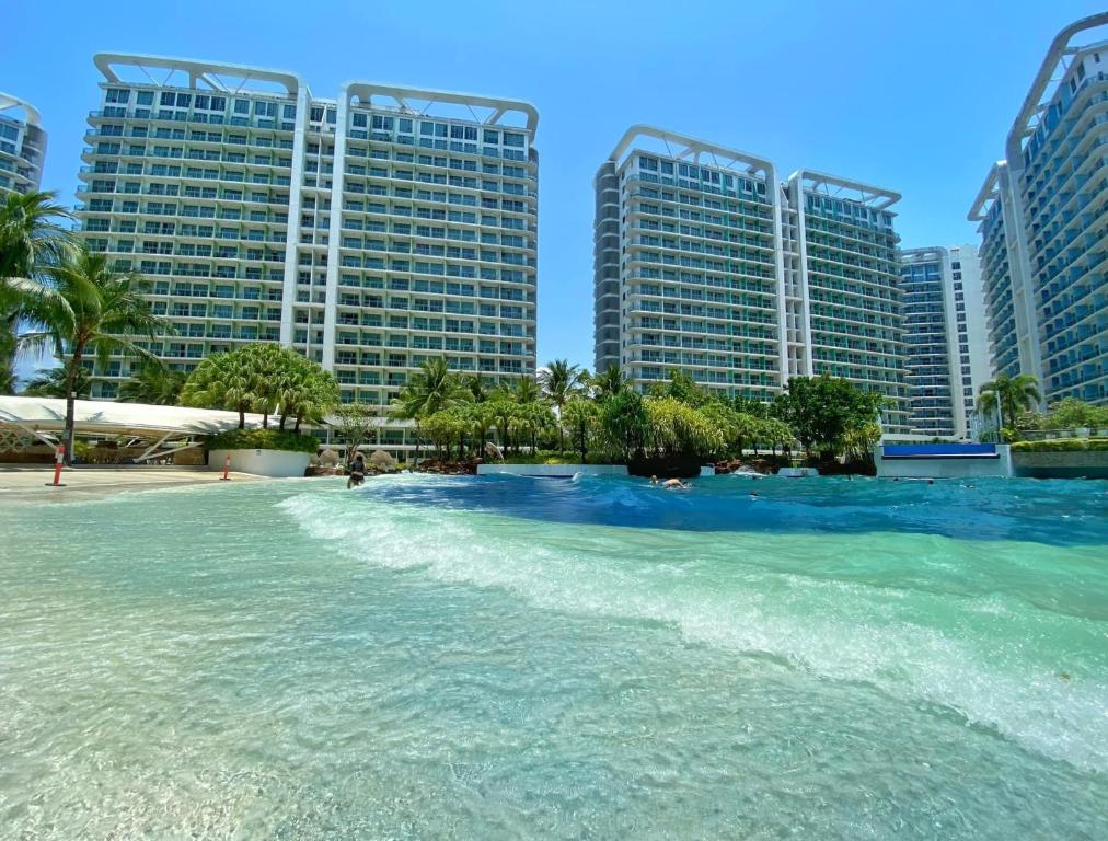 a body of water with tall buildings in the background at S&N Azure Staycation in Manila