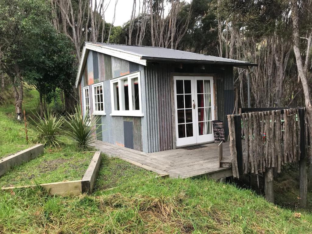 a small shed with a porch and a deck at Kanuka Retreat in Akaroa