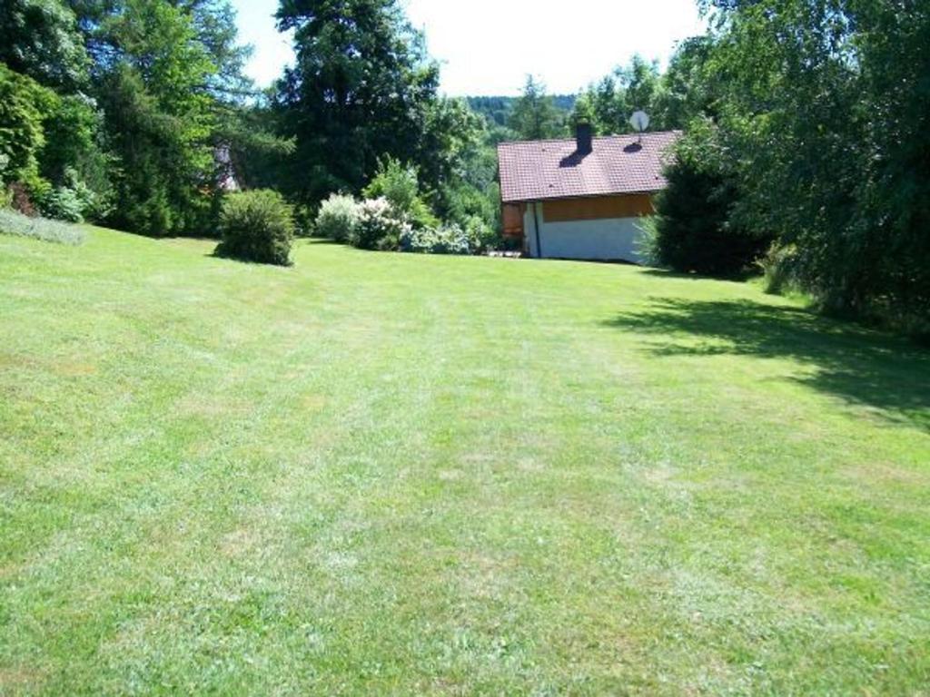 a large grassy yard with a house in the background at Gîte Anould, 4 pièces, 6 personnes - FR-1-589-2 in Anould