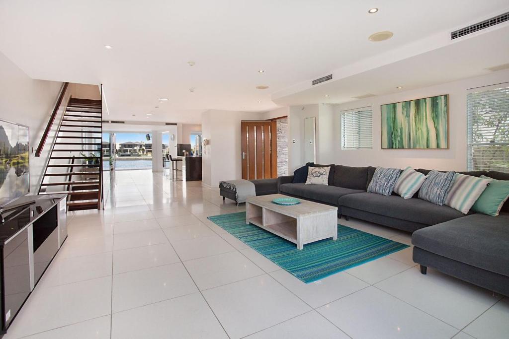 a living room with a couch and a table at A Perfect Stay - Casa Grande On The Water in Gold Coast