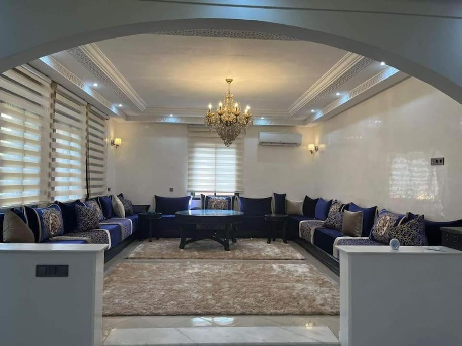 a living room with couches and a chandelier at Villa Anis- VacayX - MARRAKECH in Marrakech