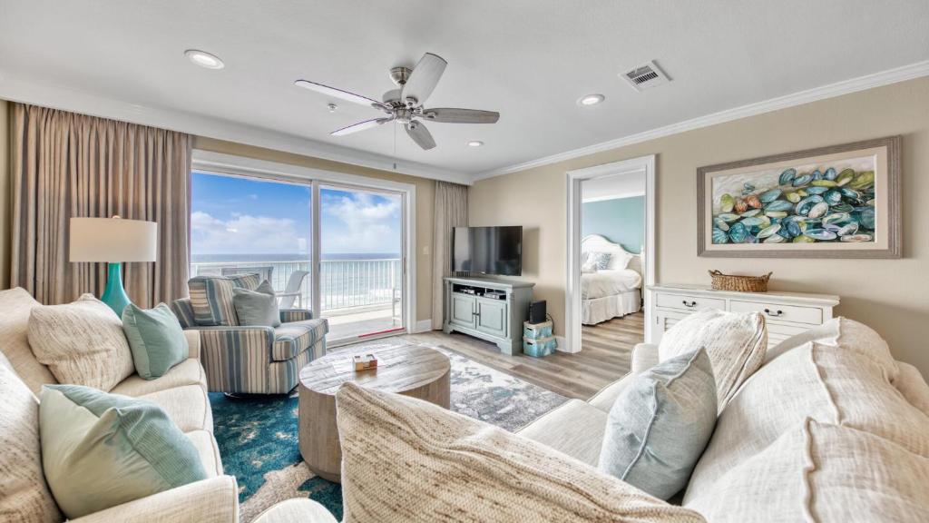 a living room with a couch and a tv at Crystal Dunes 405 - 3 BR Beach Front in Destin