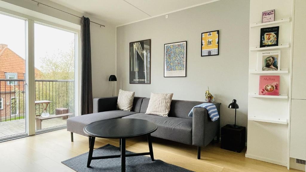 a living room with a couch and a table at ApartmentInCopenhagen Apartment 1561 in Copenhagen