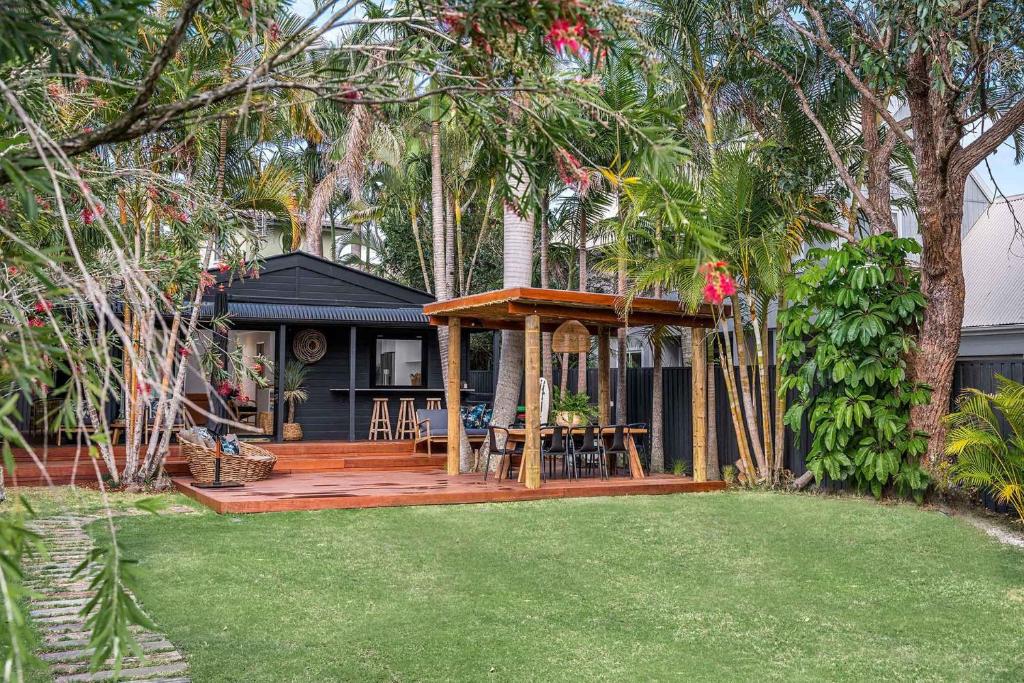 a house with a wooden deck with a gazebo at A Perfect Stay - 3 Salty Sisters in Byron Bay