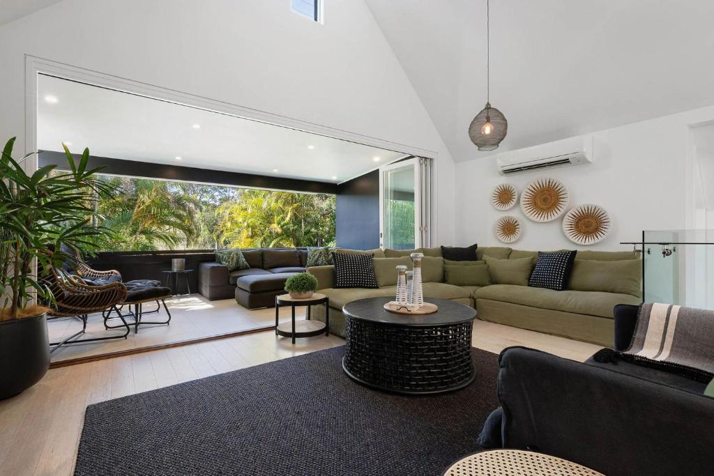 a living room with a couch and a table at A Perfect Stay - Arya in Byron Bay