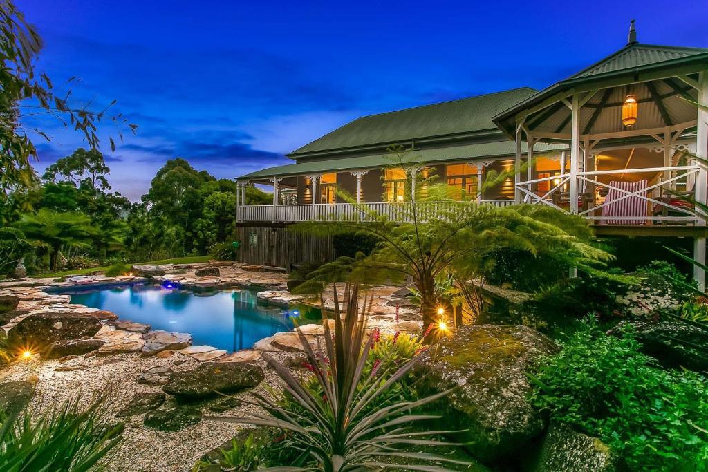 a large house with a pool in front of it at Bangalla - luxury hinterland retreat with pool in Coorabell Creek