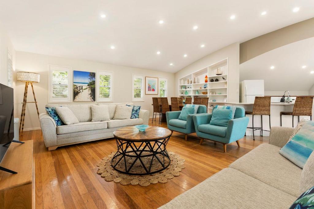 a living room with a couch and chairs and a table at A Perfect Stay - Beach House at Tallows in Byron Bay