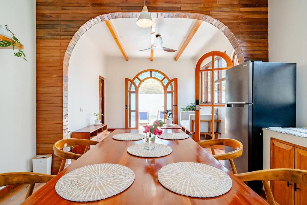 a dining room with a table and a refrigerator at Villa Markisa - luxury private pool villa Gili Air in Gili Air