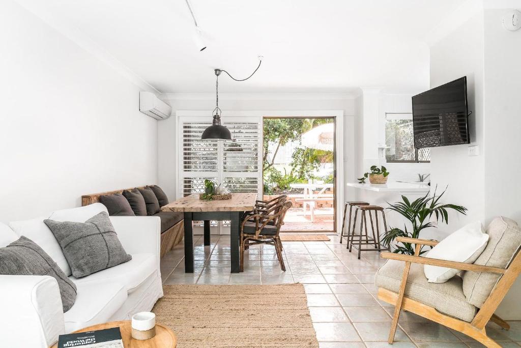 a living room with a couch and a table at A Perfect Stay - Cooinda in Byron Bay