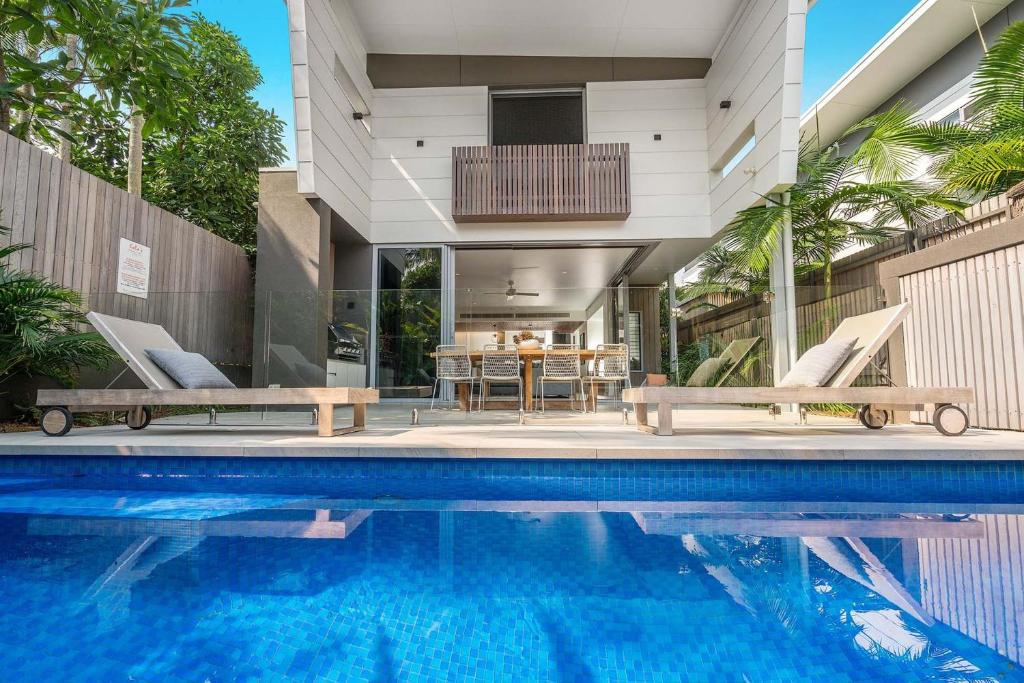 a swimming pool in front of a house at A Perfect Stay - KoKos Beach House 2 in Byron Bay