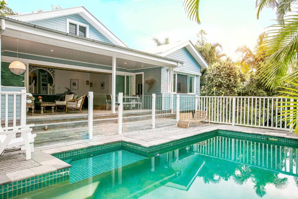 a swimming pool in front of a house at A Perfect Stay - Kia Ora Byron in Byron Bay