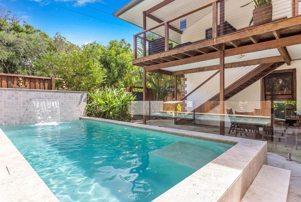 a swimming pool in the backyard of a house at Skye Lodge - 7 Bedroom charming Balinese retreat with designer pool in Byron Bay