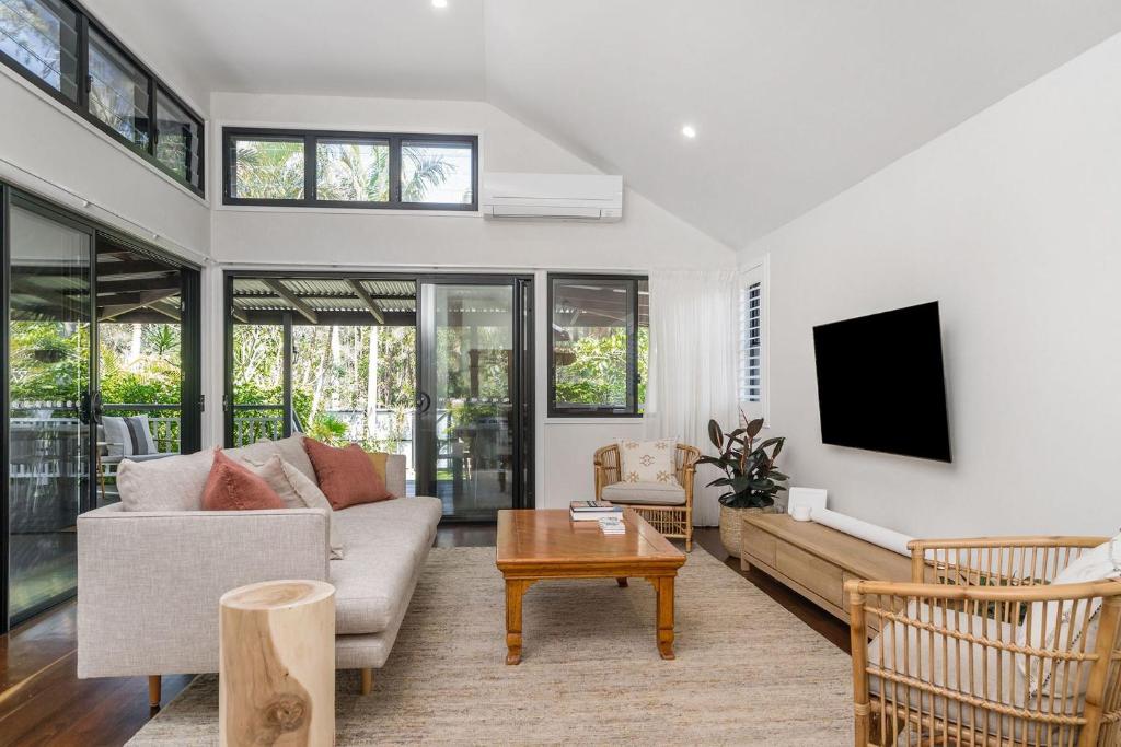 a living room with a couch and a table at A Perfect Stay - Solstice in Byron Bay