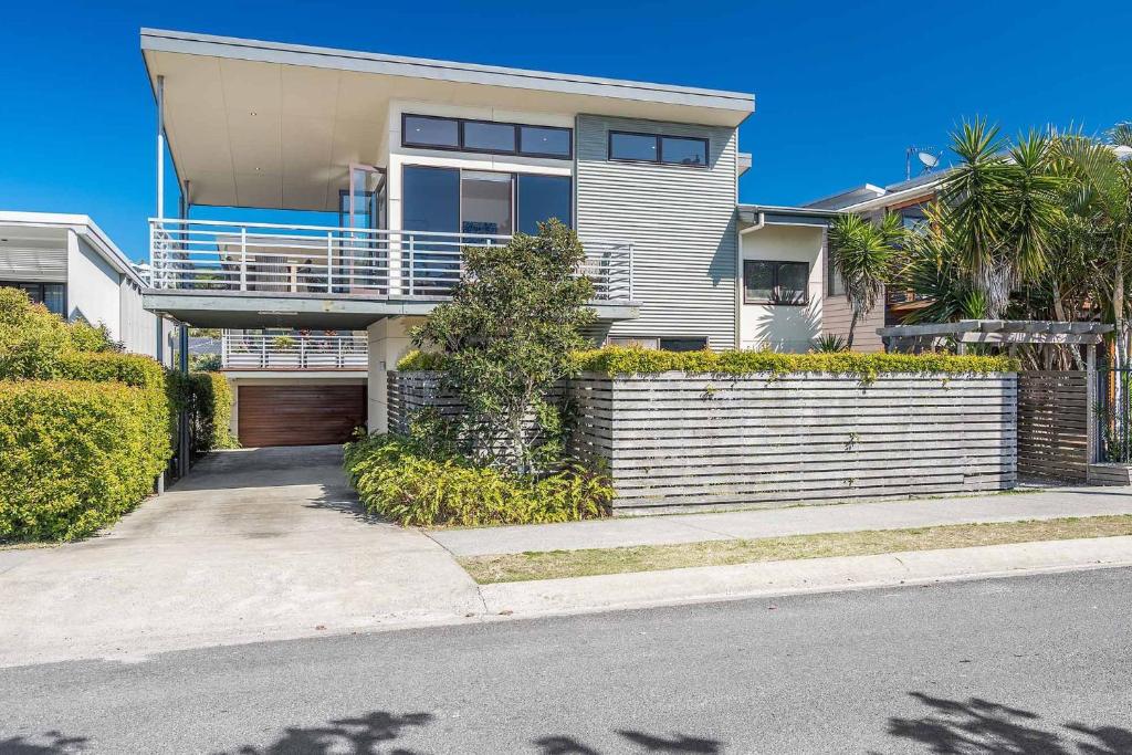 a large house with a fence and a driveway at A Perfect Stay - Sandy Feet in Lennox Head