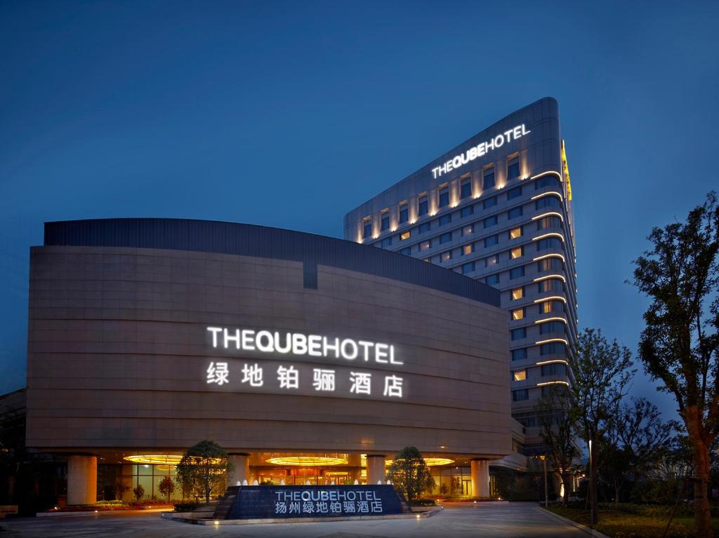 a hotel with a sign on the side of it at The QUBE Hotel Yangzhou in Yangzhou