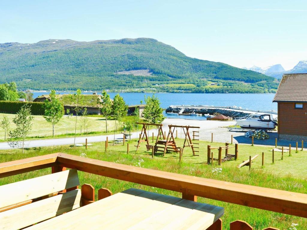 a picnic table with a view of a lake at 6 person holiday home in EIDSVÅG in Eidsvåg