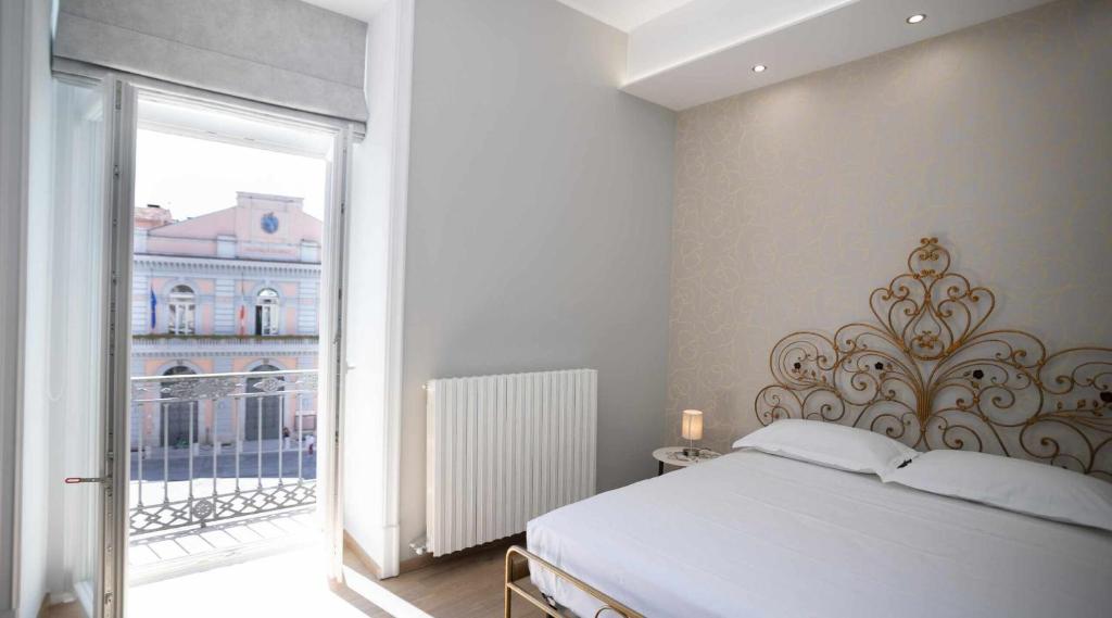 Postel nebo postele na pokoji v ubytování Palazzo Brienza