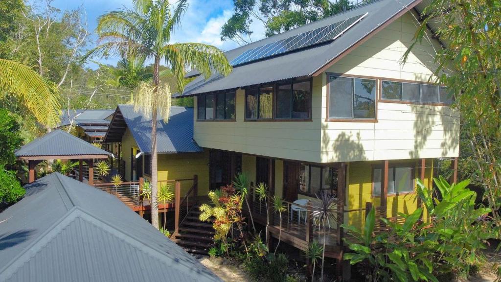 a house with solar panels on top of it at A Perfect Stay - Blue Bliss House and Studios in Byron Bay
