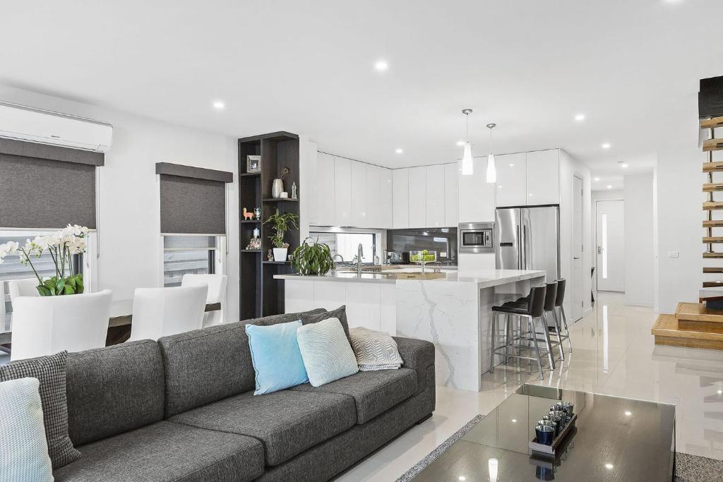 un soggiorno e una cucina con divano e tavolo di Boutique Stays - Edinburgh Place a Melbourne