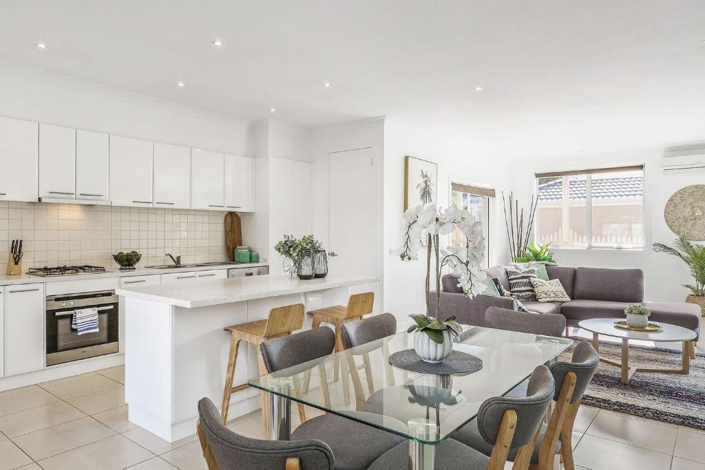 a kitchen and living room with a table and chairs at Boutique Stays - The Richardson in Mentone